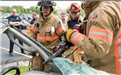 Firefighter Using Tool on Car