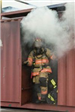 Firefighter Walking out of Smoky Structure