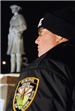 Police Officer Standing in Front of Statue